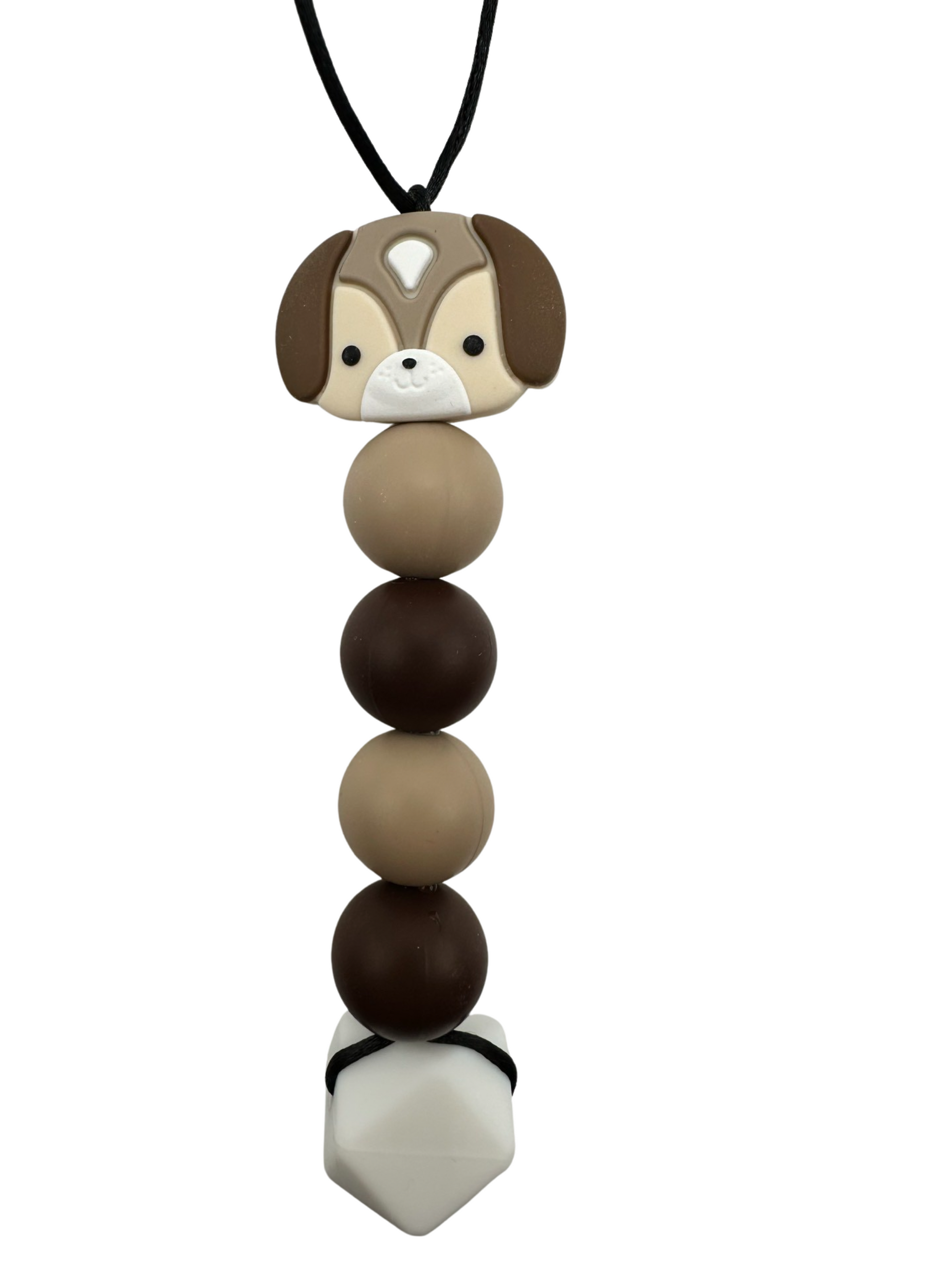A chewable bead necklace. There is a brown and tan dog head bead followed by four round beads in the following colours: tan, brown, tan, brown. There is a large white hexagon bead at the bottom.