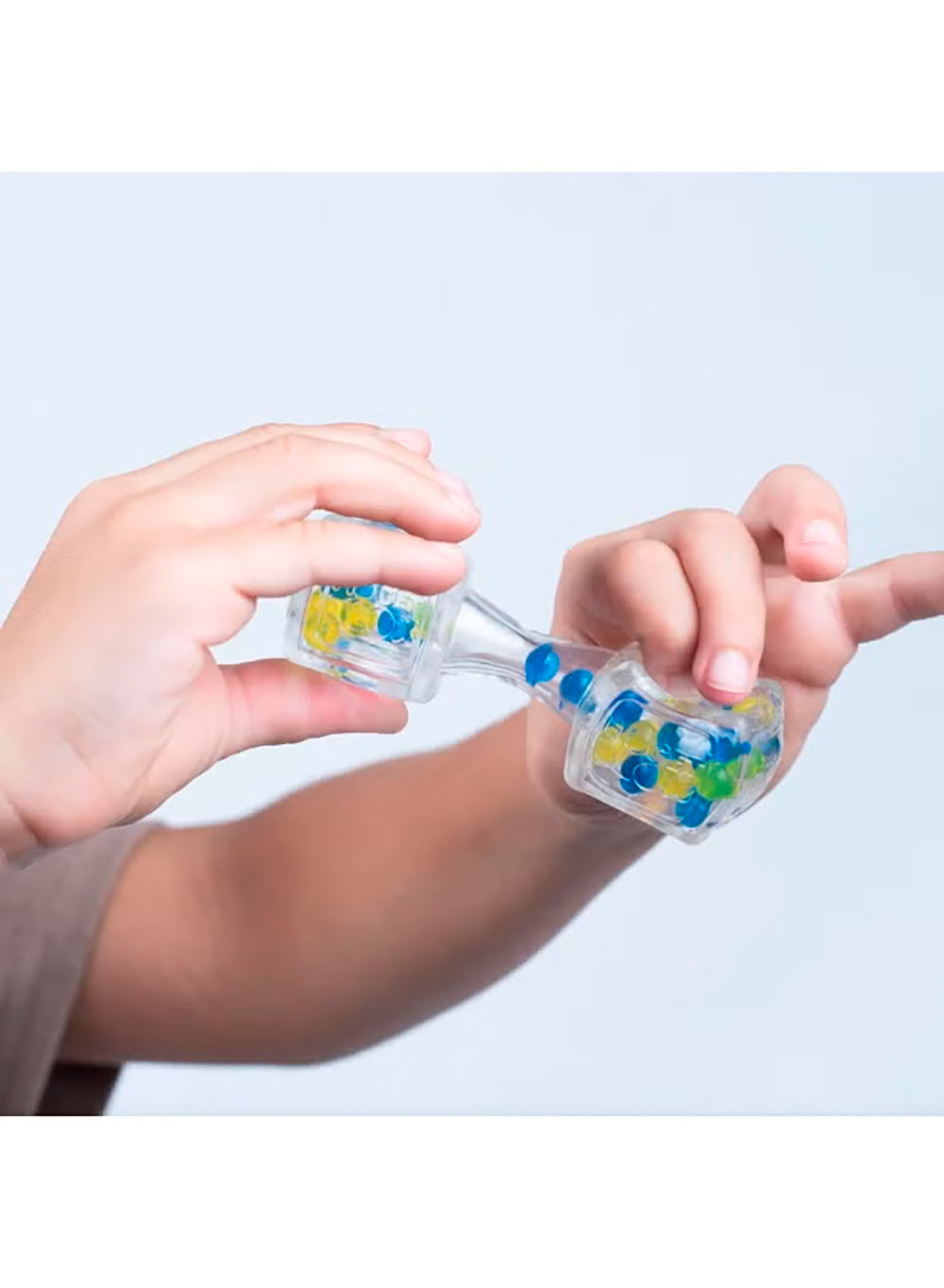 Two hands holding the Sound focused figet blox with blue and green beads against a light gray background