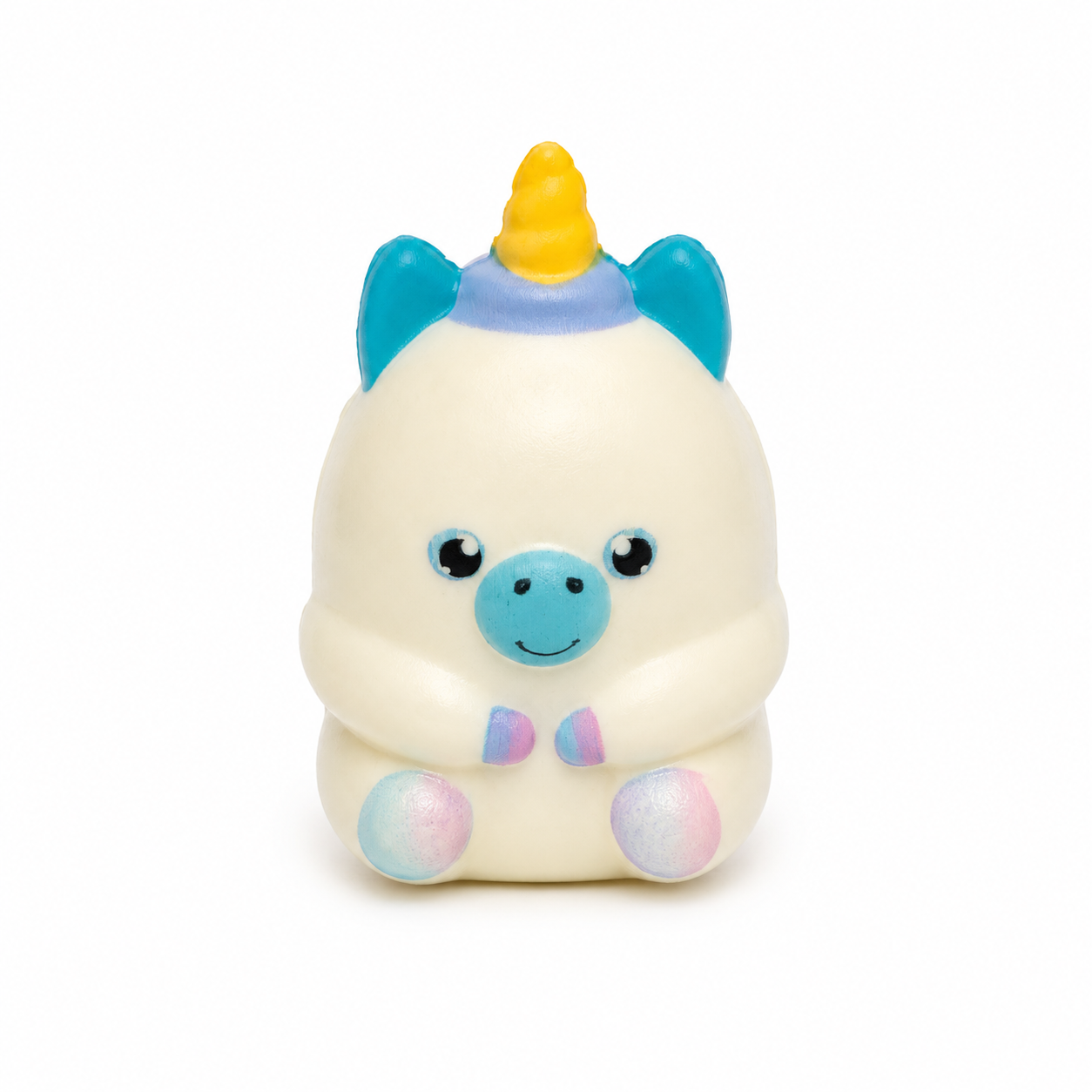 Small white-coloured unicorn squishy with a yellow horn, teal ears and muzzle, pastel hooves, and a tiny pastel bow tie, shown from the front against a white background.