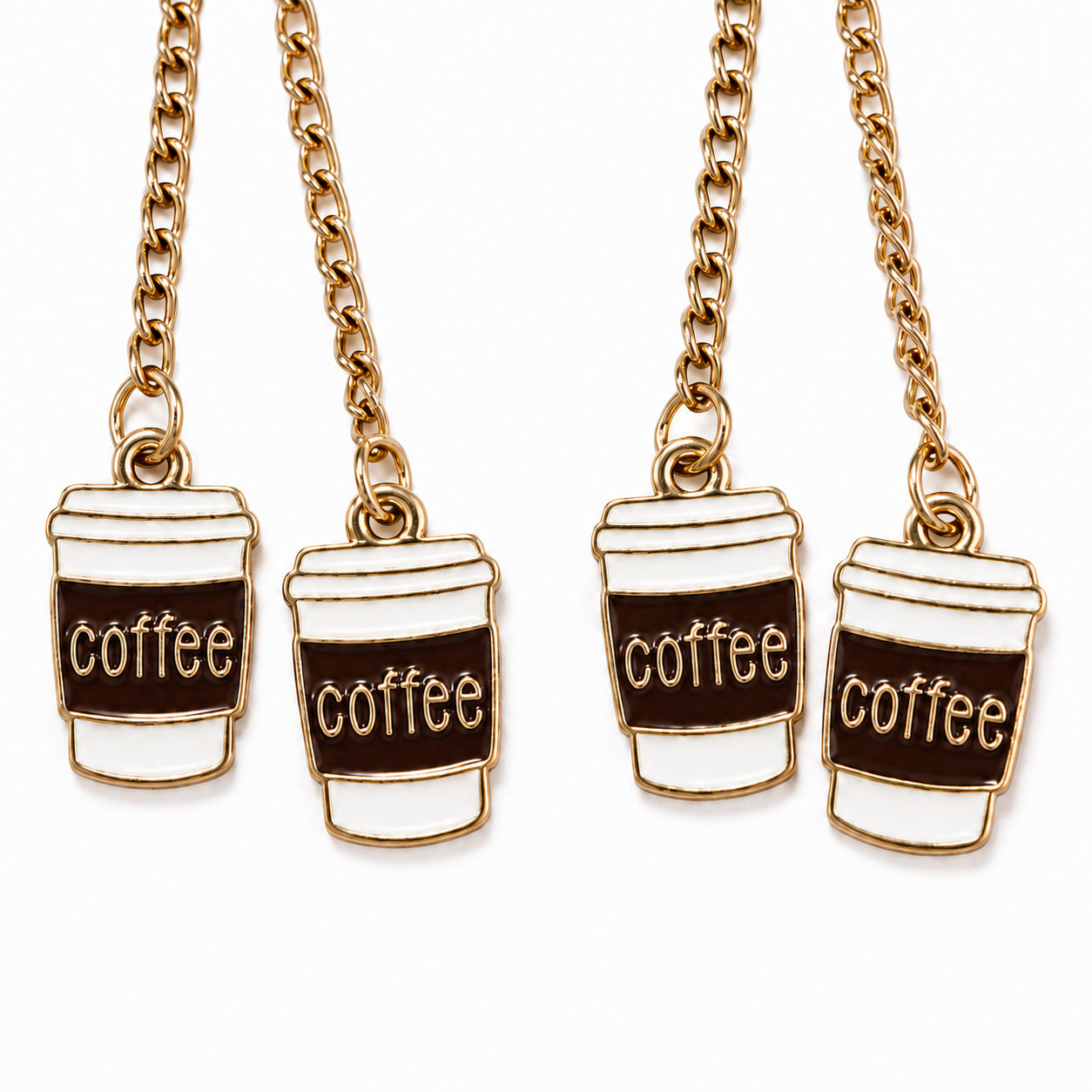 Close-up of four white takeaway coffee cup charms with dark brown sleeves, gold-tone outlines, and “coffee” lettering, hanging from gold-tone chains against a white background.