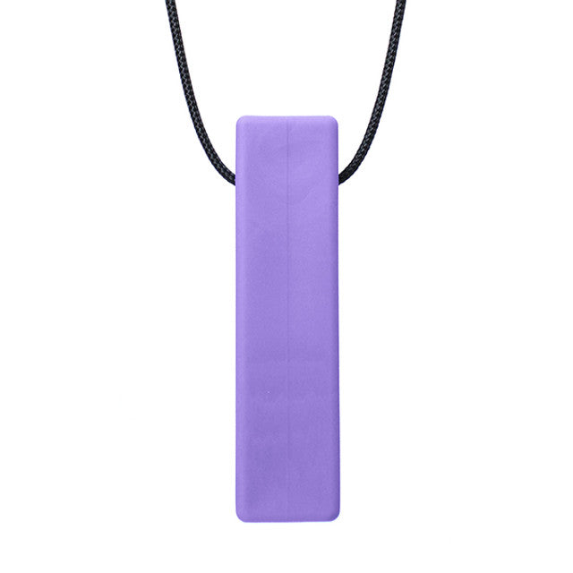 There is a smooth brick shaped pendant on a black cord. The pendant is lavendar coloured and designed to be chewed on. 